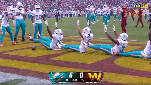Dolphins players celebrate after Tyreek Hill (left) scored a touchdown.
